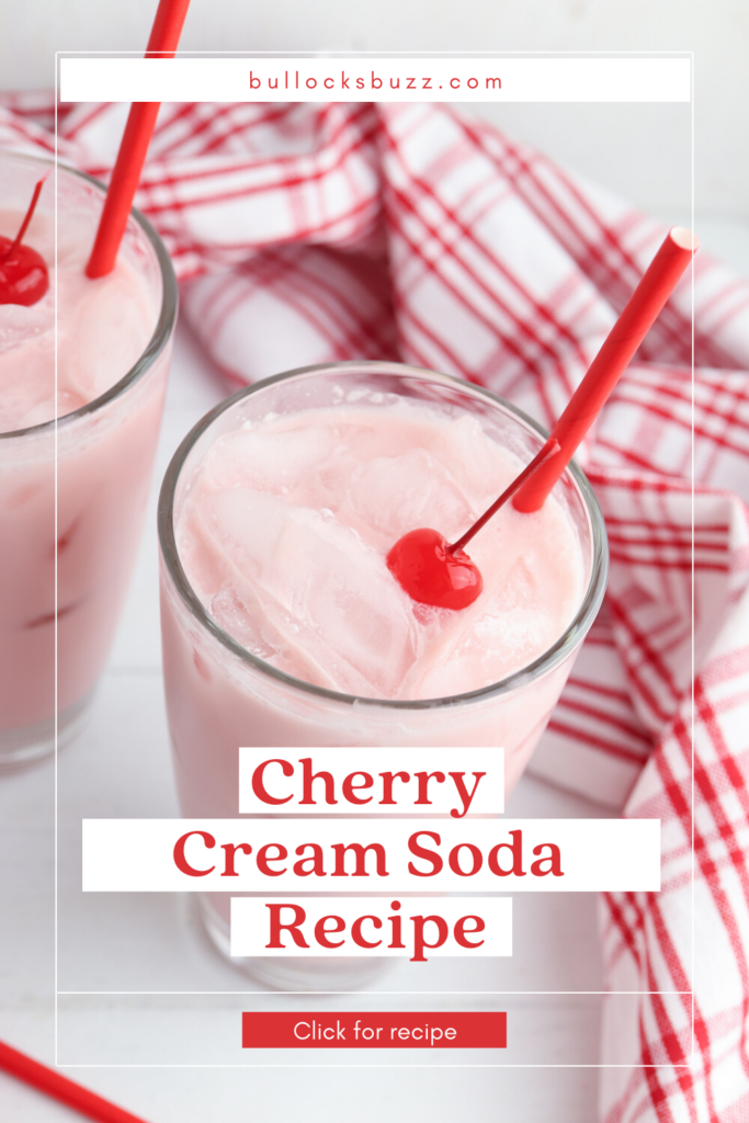 Pretty pink cherry cream soda garnished with a cherry in a tall glass