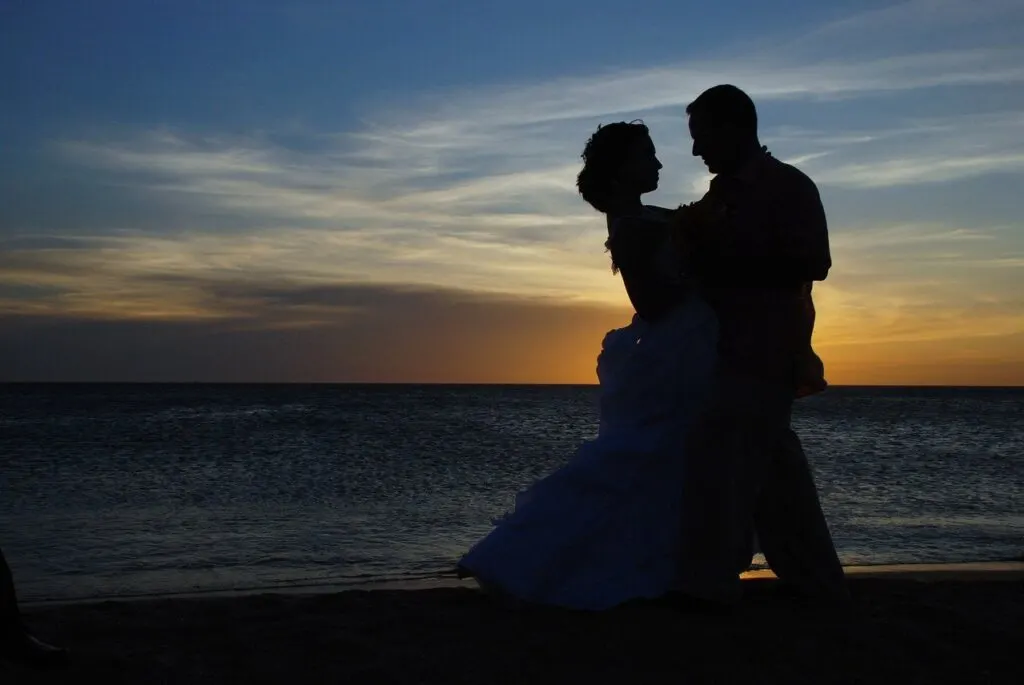bride and groom at sunset beach wedding