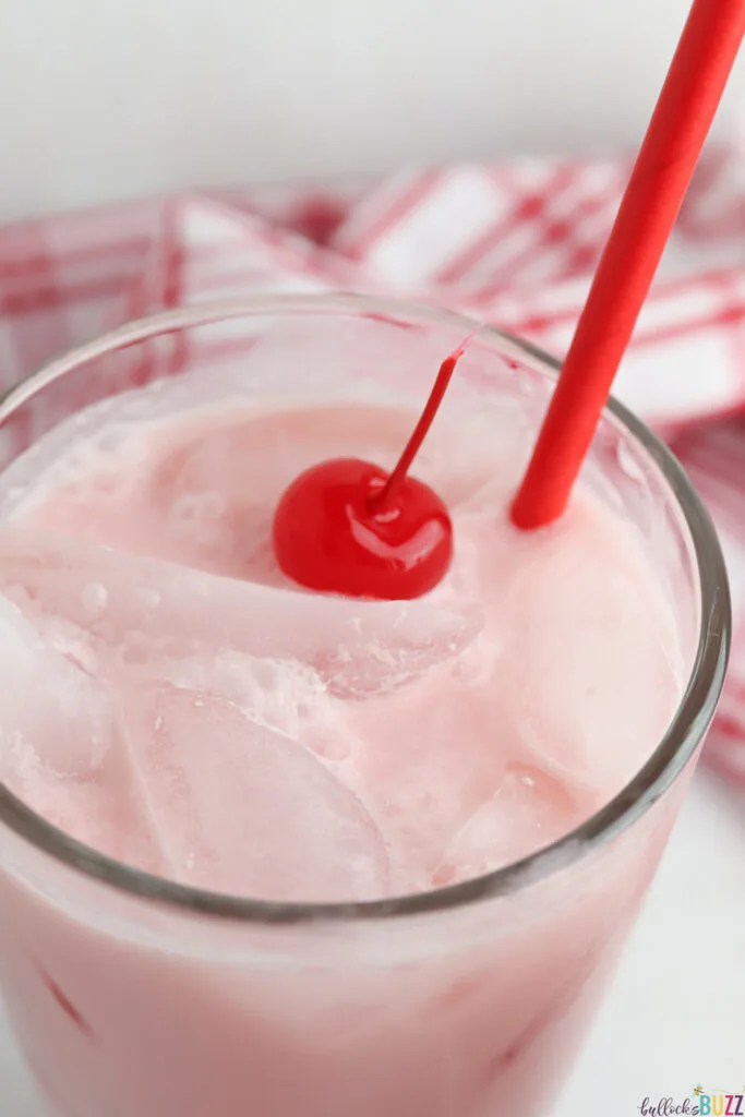 pink drink garnished with a cherry