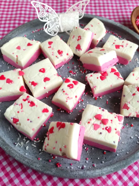 pink and white layered Valentine's Day fudge cut into squares
