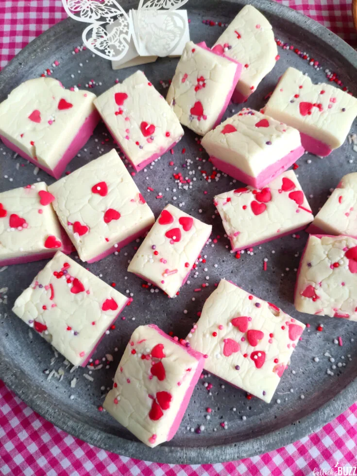 overhead shot of pink and white layered fudge on a plate