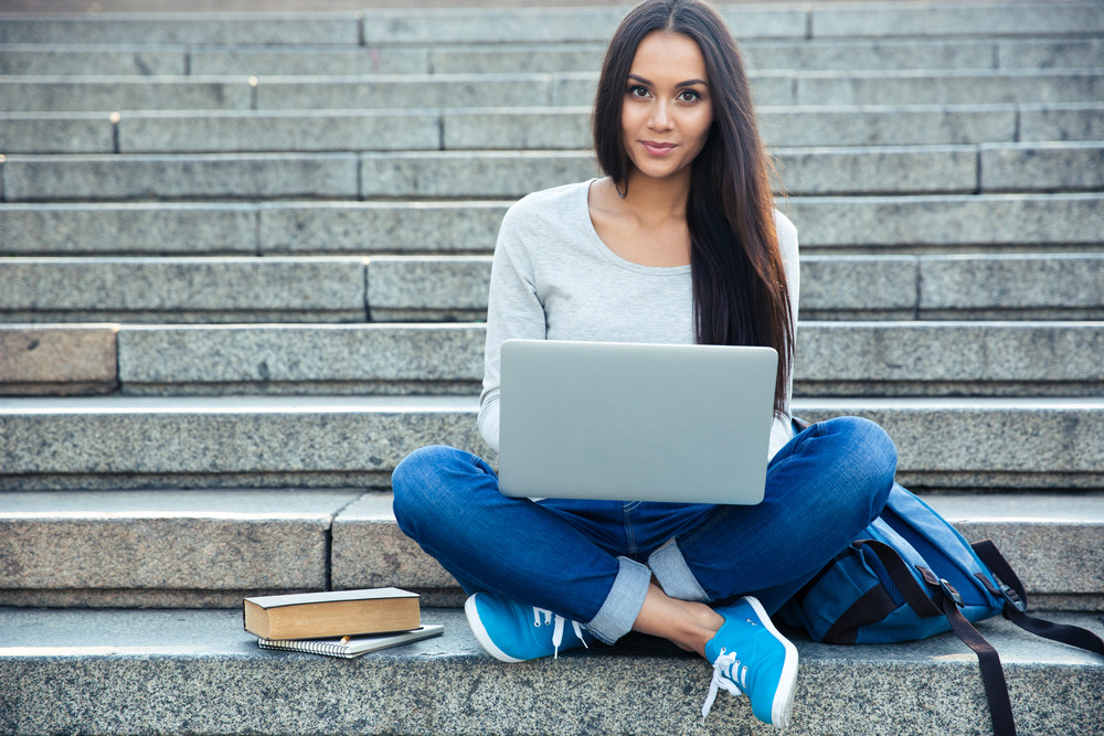 woman working on her laptop to learn how to turn your side hustle into a successful small business