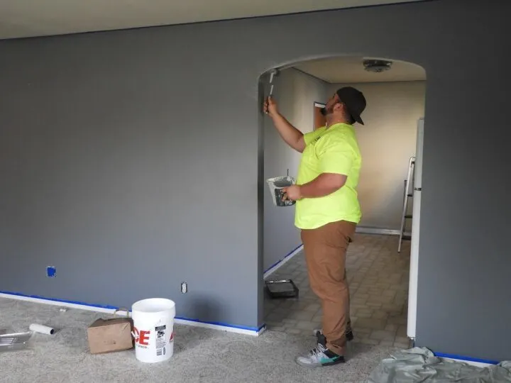 man painting a room in a house