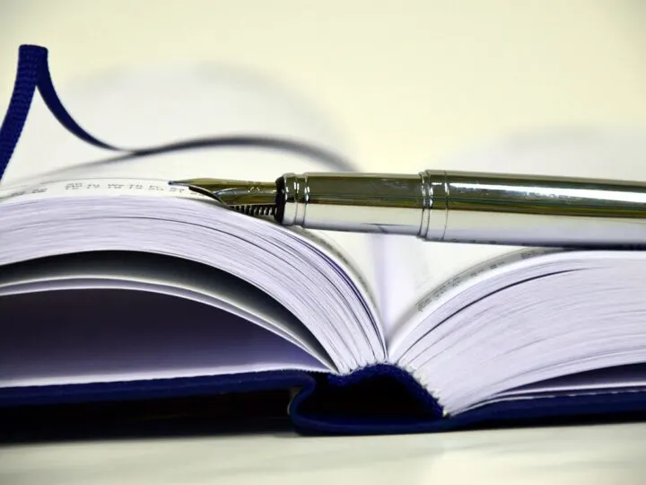 a pen on top of an open notebook