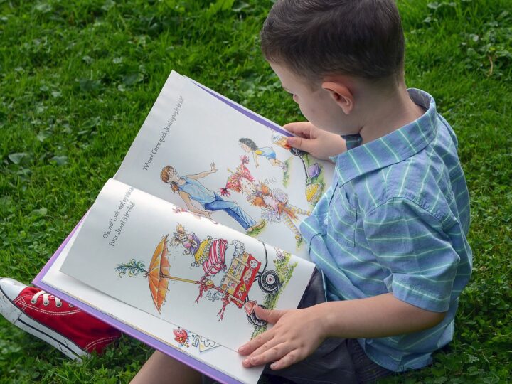 little boy looking at a book 