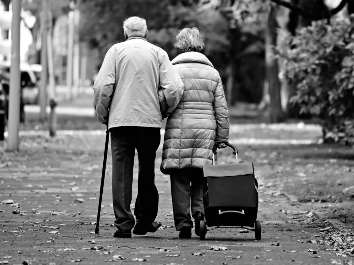 elderly couple walking together