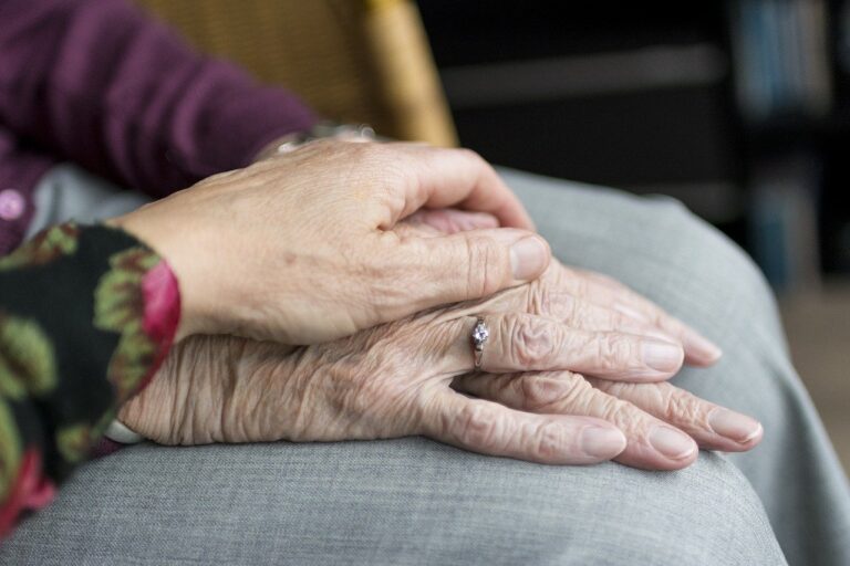 daughter holding moms hand while learning how to prepare for an elderly parent moving in