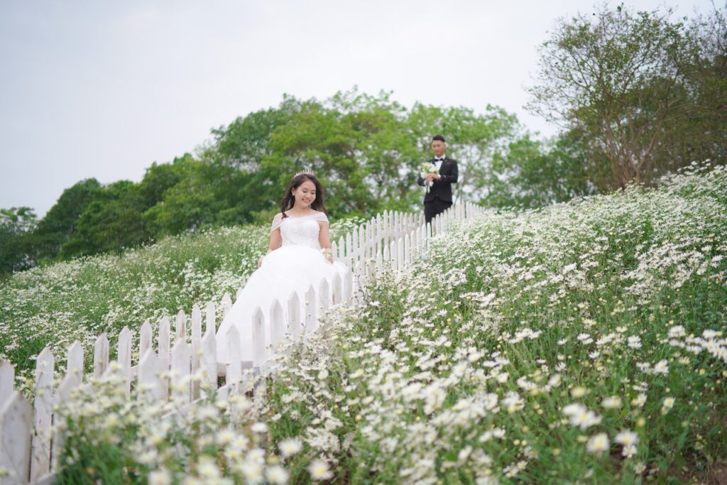 wedding gown on bride in field of flowers