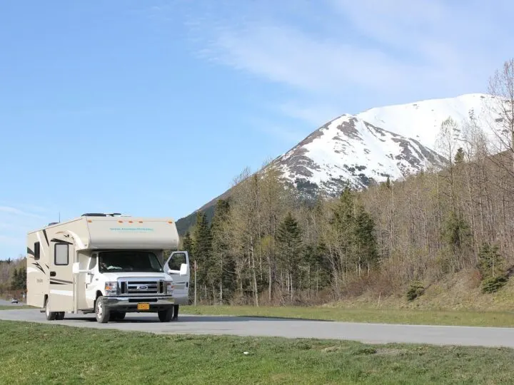 RV parked in front of mountains