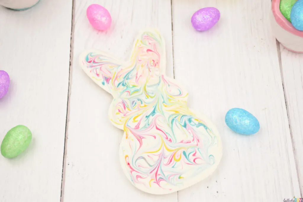 white chocolate bunny with pink, yellow and blue swirls