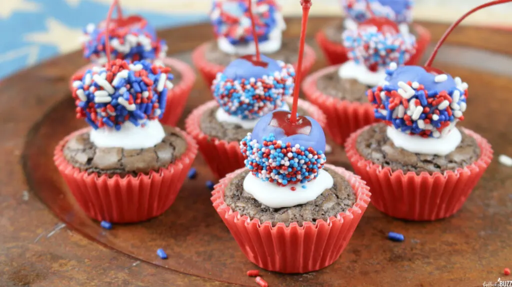 patriotic brownie bites in red wrappers lined up on a tray