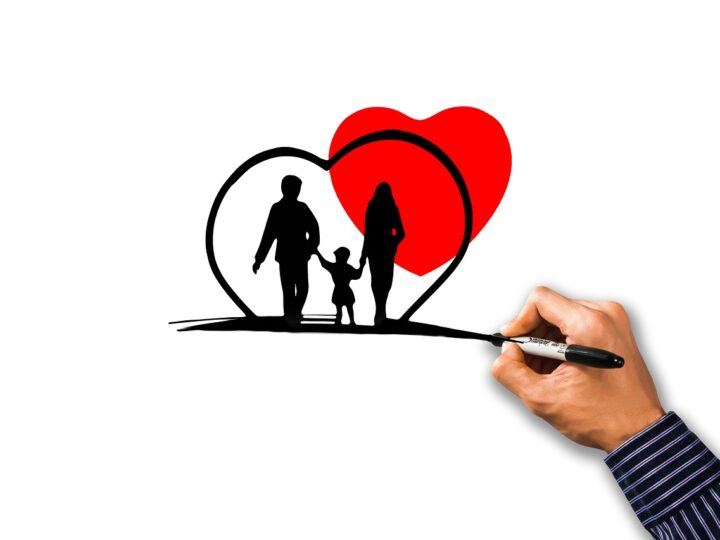 man drawing a heart around a family