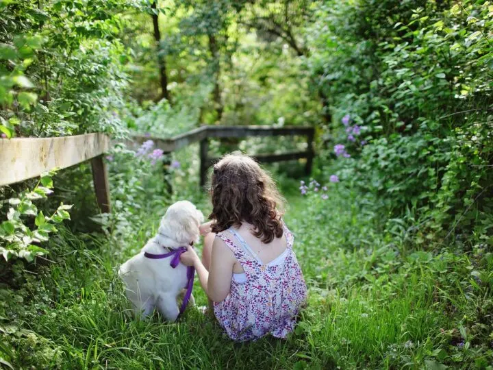little girl with her dog and helping your child cope with the loss of a pet