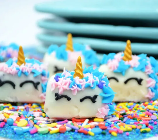 unicorn petit fours in front of blue plates
