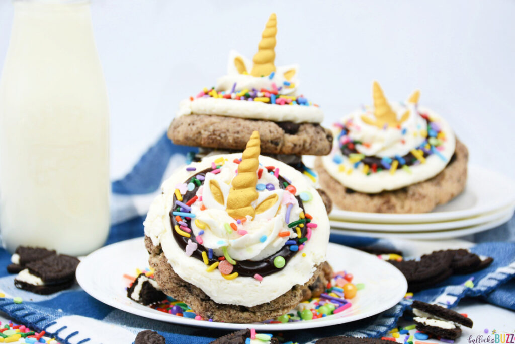 cookies stacked on a plate with a glass of milk in the background