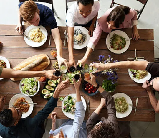 people sitting around a table playing dinner party games