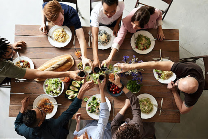 people sitting around a table playing dinner party games