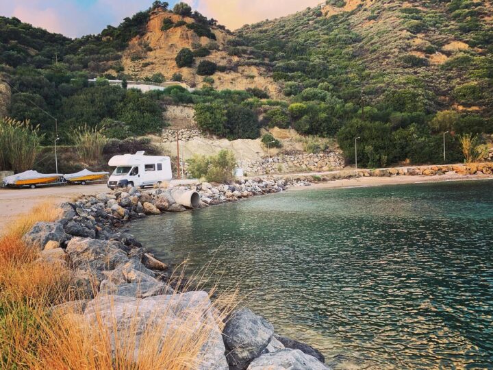 van parked by lake on a van camping trip