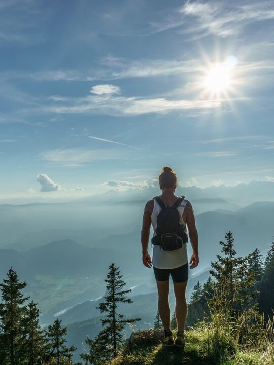woman hiker standing at top of mountain