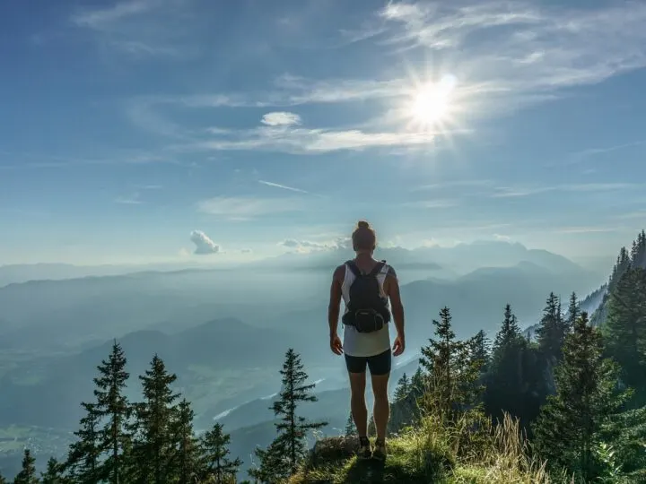 woman hiker standing at top of mountain