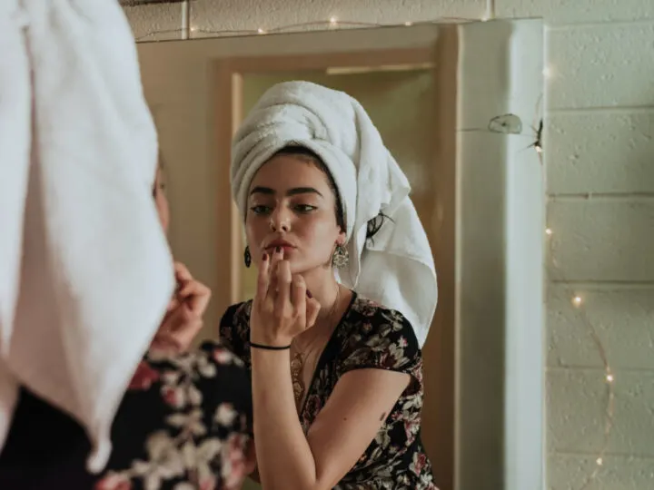 woman applying lotion as way to enhance your skincare routine