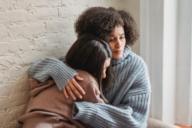 woman comforting upset girl