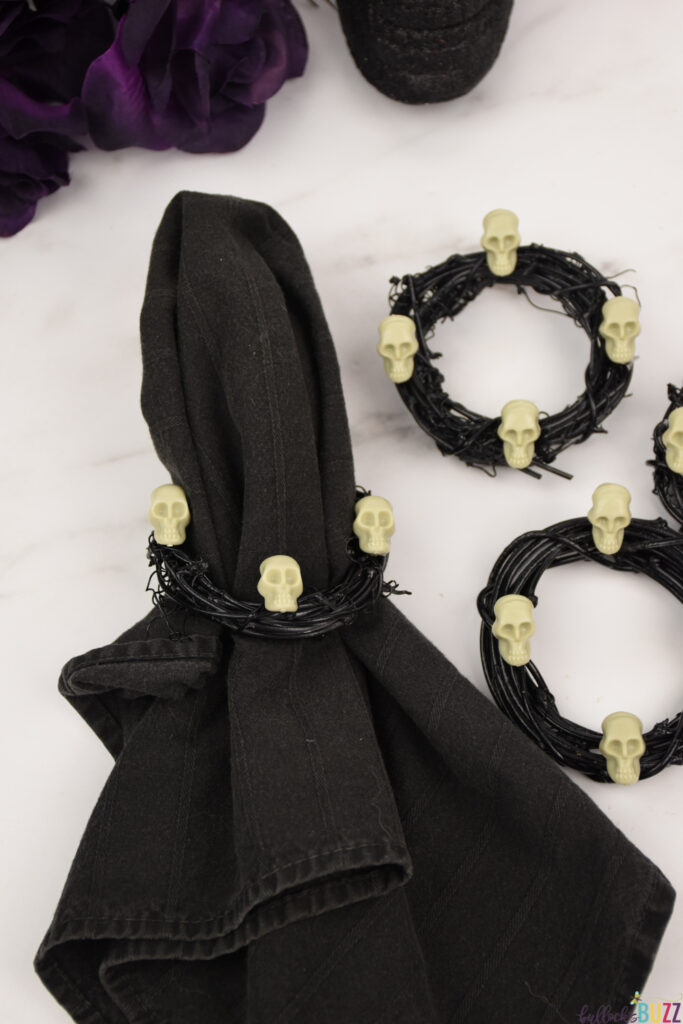 Halloween napkin holders made of black grapevine wreaths and plastic skulls