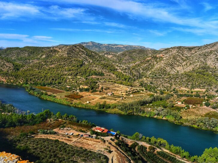 a farm next to a river with all the essentials to live off the grid