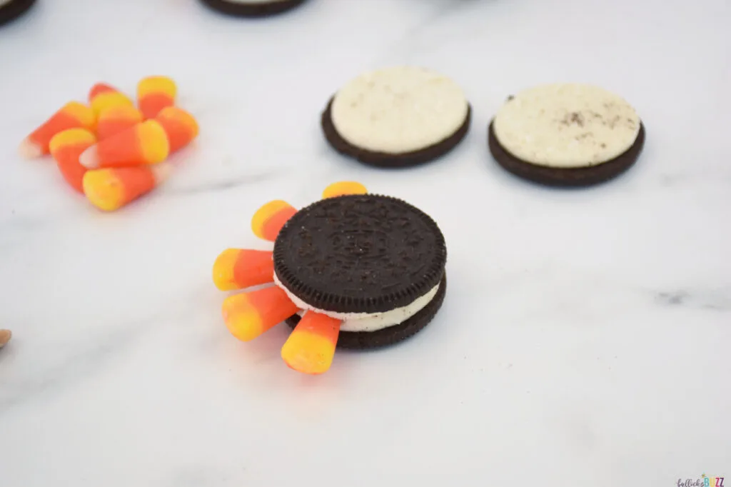 stick candy corn in between the cookies to make feathers