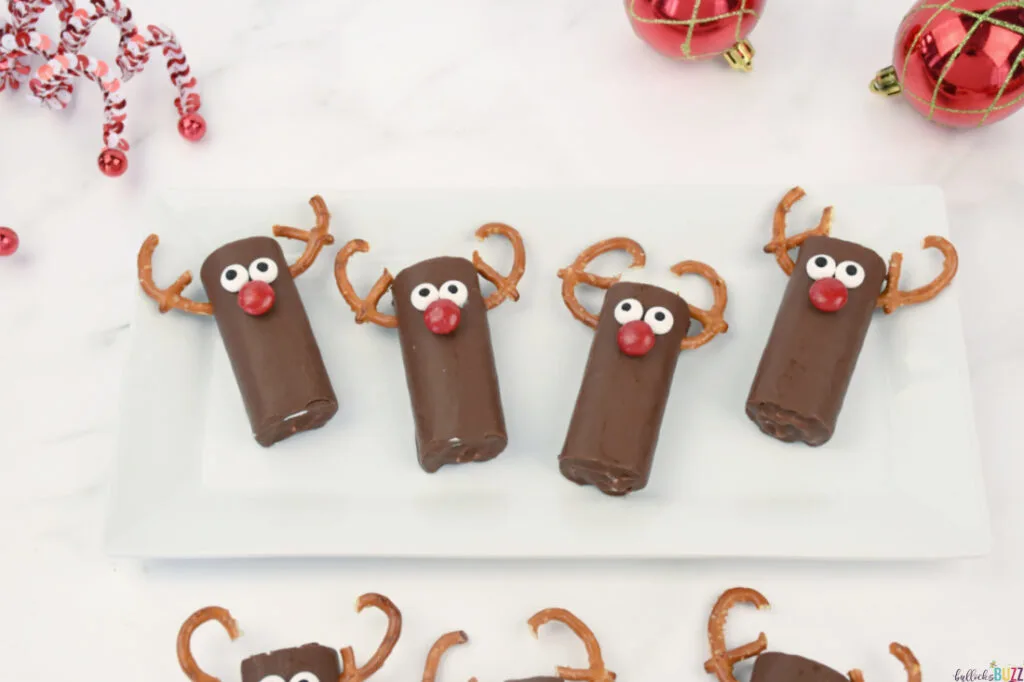 four reindeer snack cakes in a row on a plate