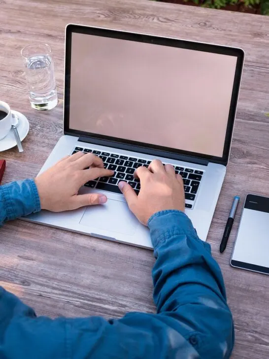 man working on restaurant website on his laptop