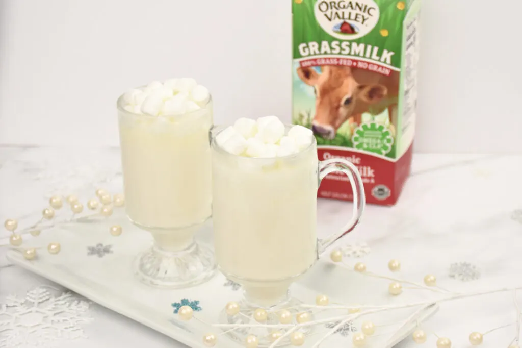 Organic Valley milk carton behind cups filled with white hot chocolate recipe