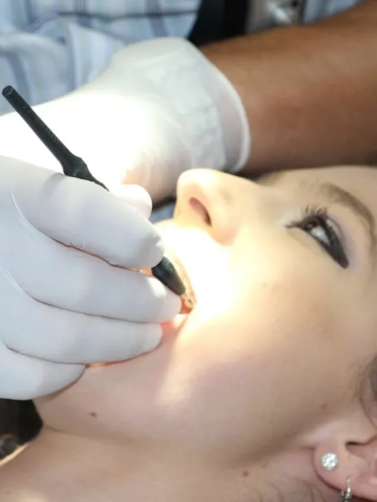 a woman at the dentist getting one of the most common dental procedures