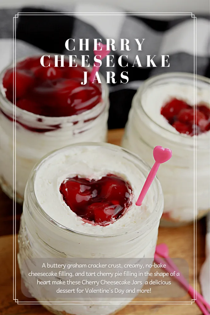 Three cherry topped cheesecakes in jars