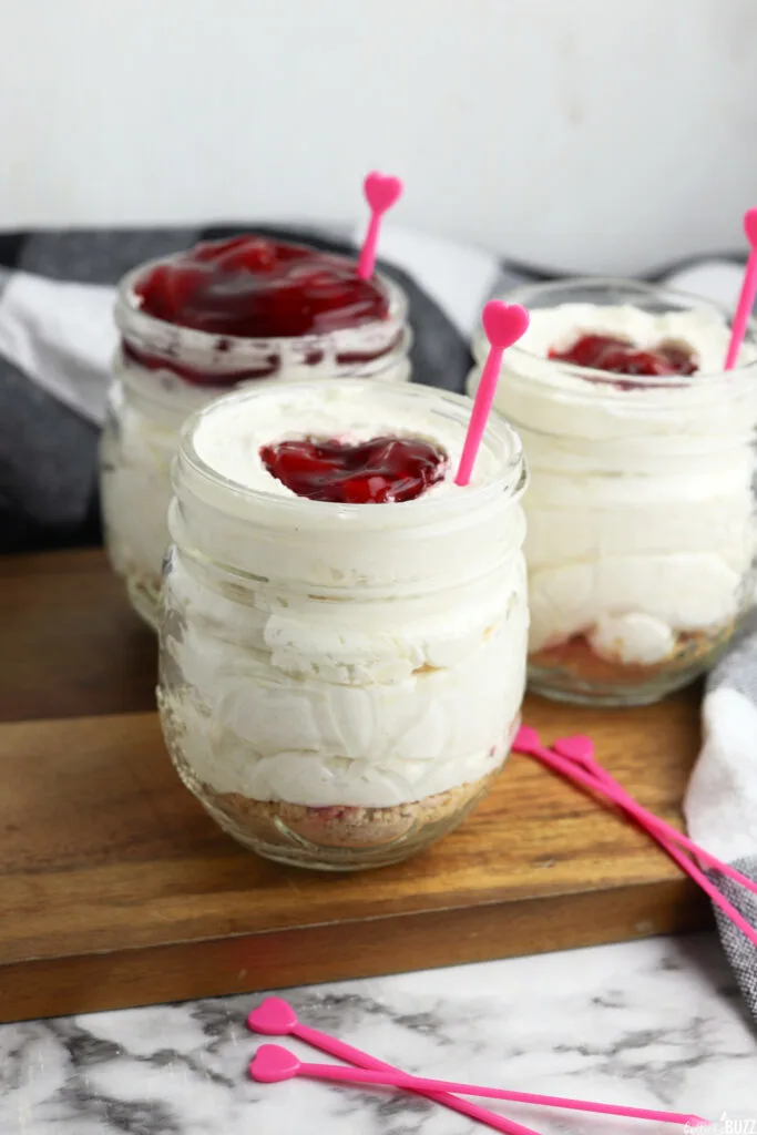 side view of cherry cheesecake in a jar