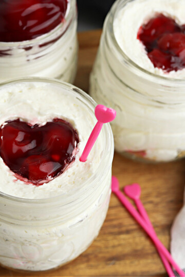 cherry cheesecake jars on cutting board