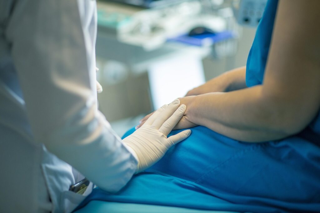 when discussing the impact of mesothelioma, doctors should offer comfort like this one is by holding the patient's hand