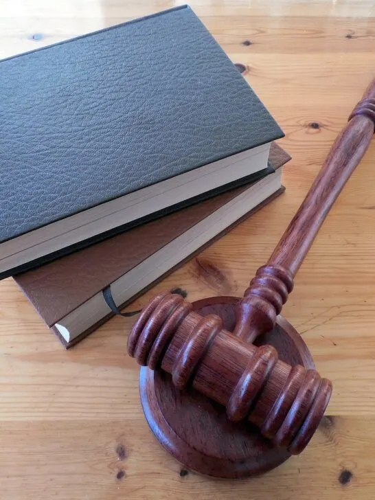 law books and a gavel represent legal resources for victims of abuse