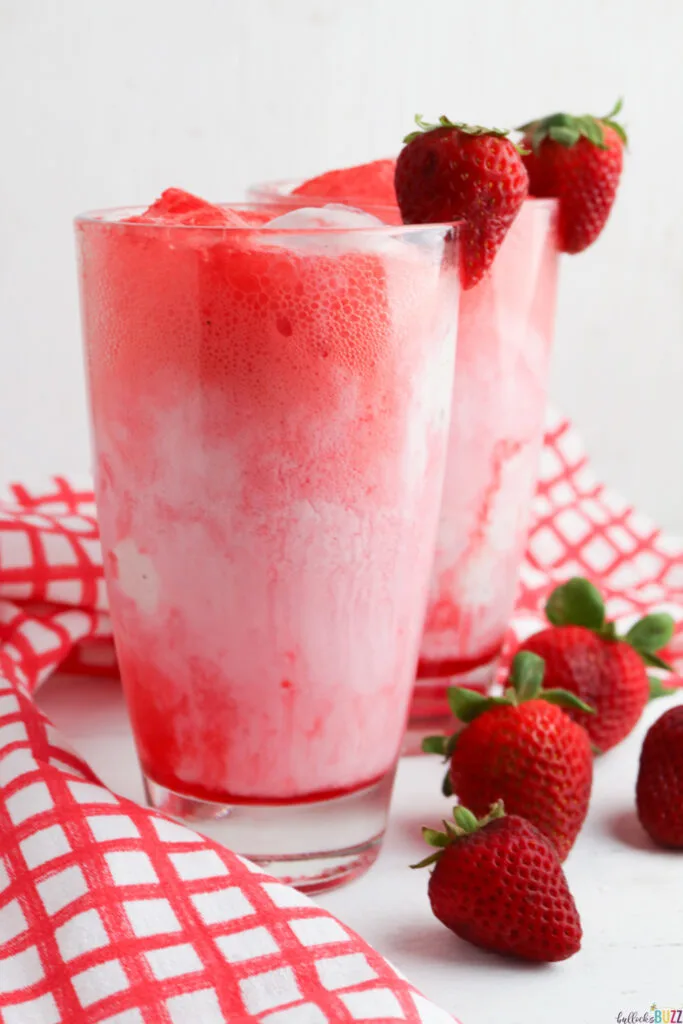 two Strawberry Floats with fresh strawberry garnish 