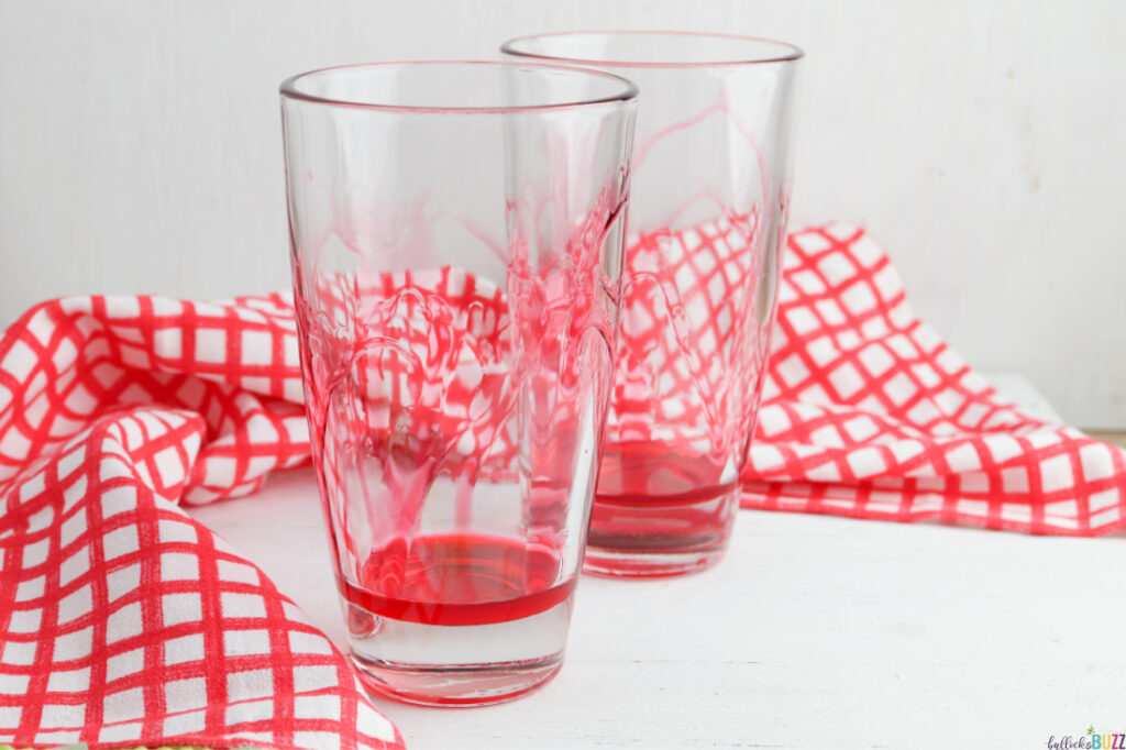 two glasses with strawberry syrup 