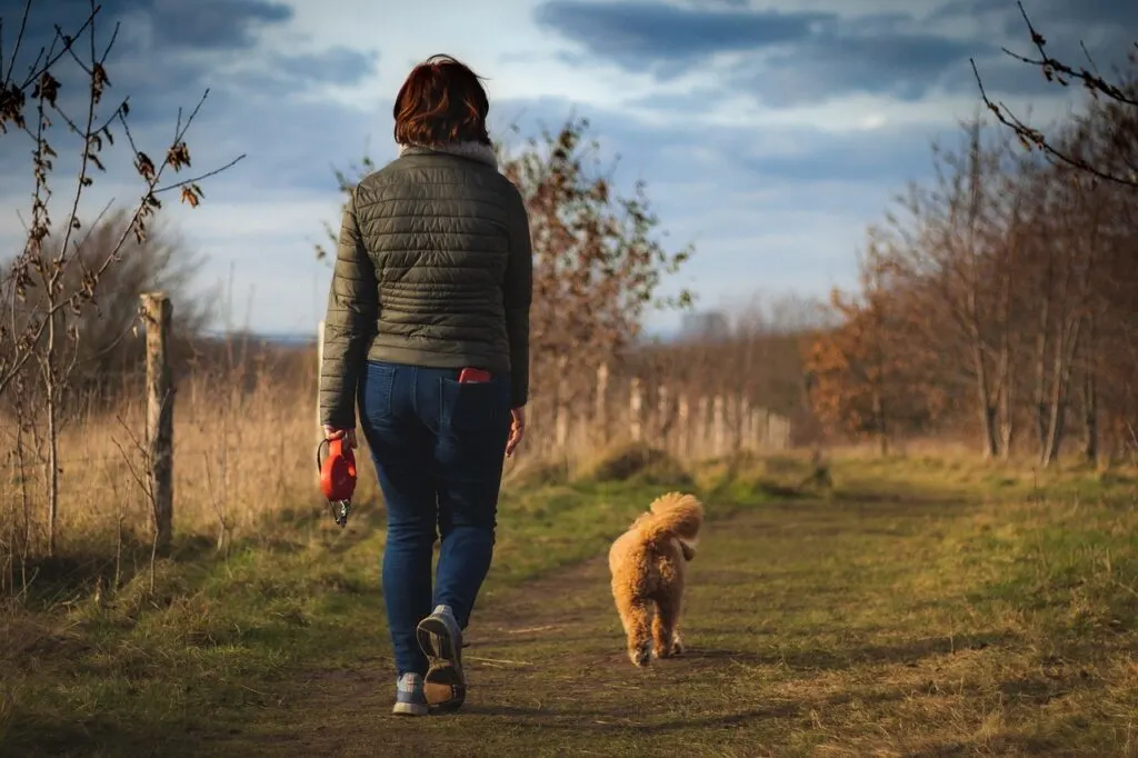 woman walking dog as way to improve your mental and physical health