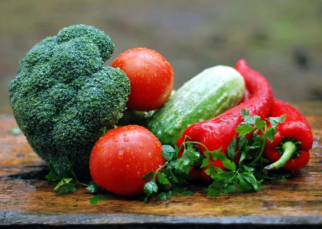 freshly washed vegetables on wood table