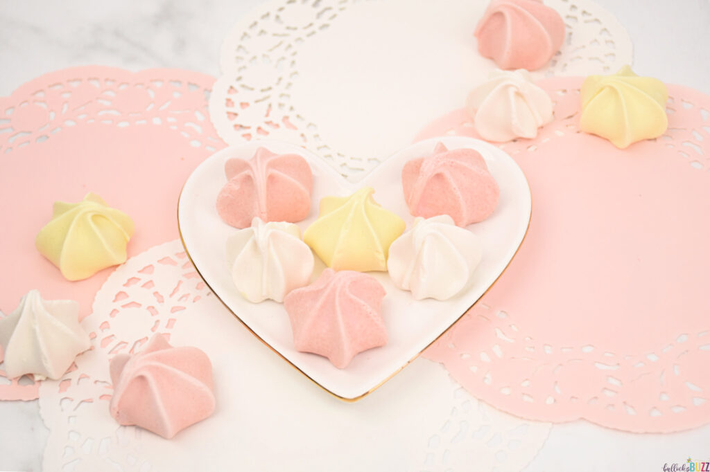 meringue cookies on heart-shaped plate