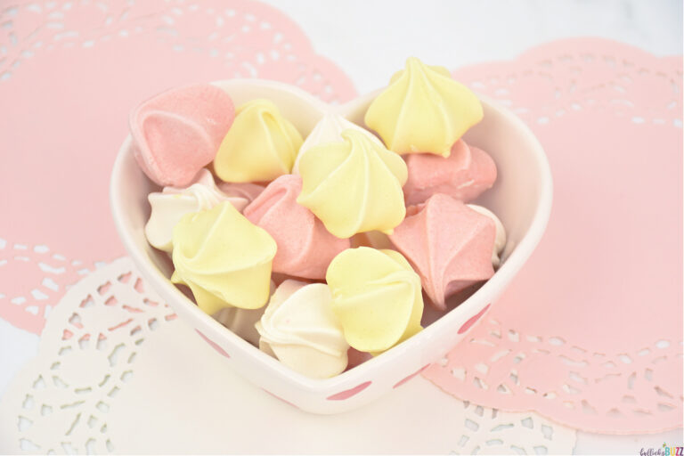 heart-shaped bowl of white, pink, and yellow Valentine's Day Meringue Cookies