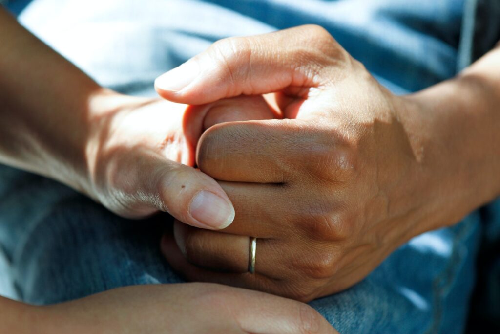 man and woman holding hands discussing American vs Canadian Health Insurance