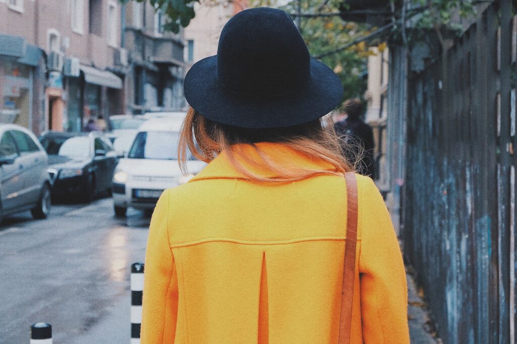 woman walking in a long coat as part of stylish winter outfits