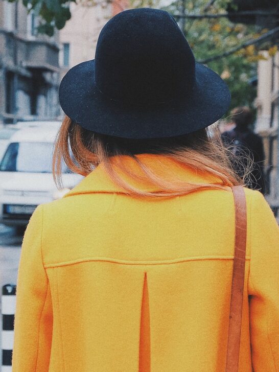 woman walking in a long coat as part of stylish winter outfits