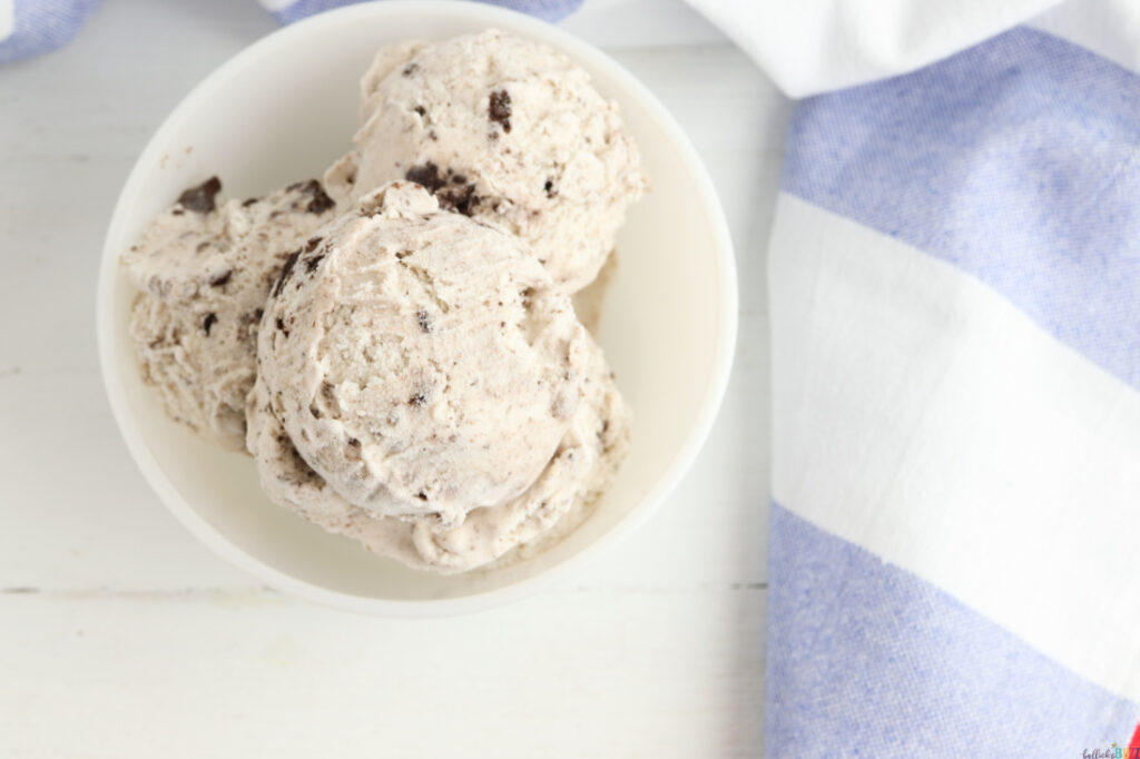 add three scoops of cookies and cream ice cream to a small bowl