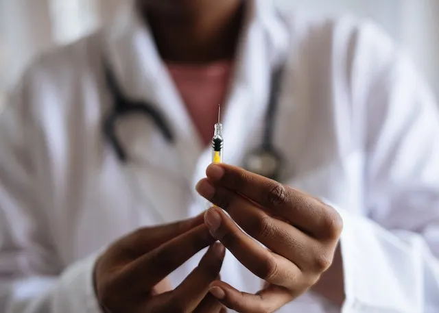 male nurse holding an injection