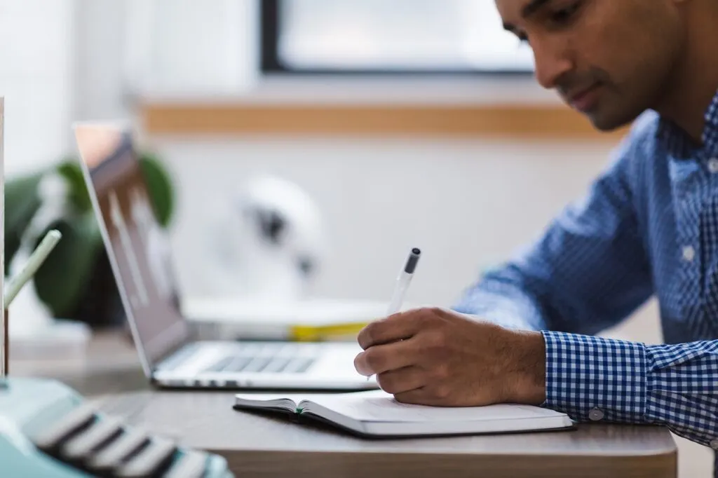 these nursing assignment hacks can help you study better and faster like this man studying on his computer 